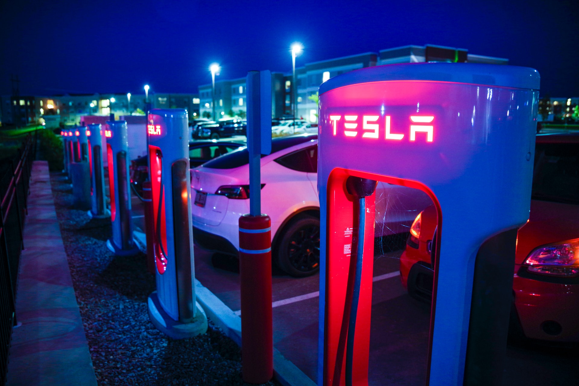 Tesla, a level 3 charging station at night.