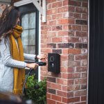 Woman charging her EV using her Private charger at home.